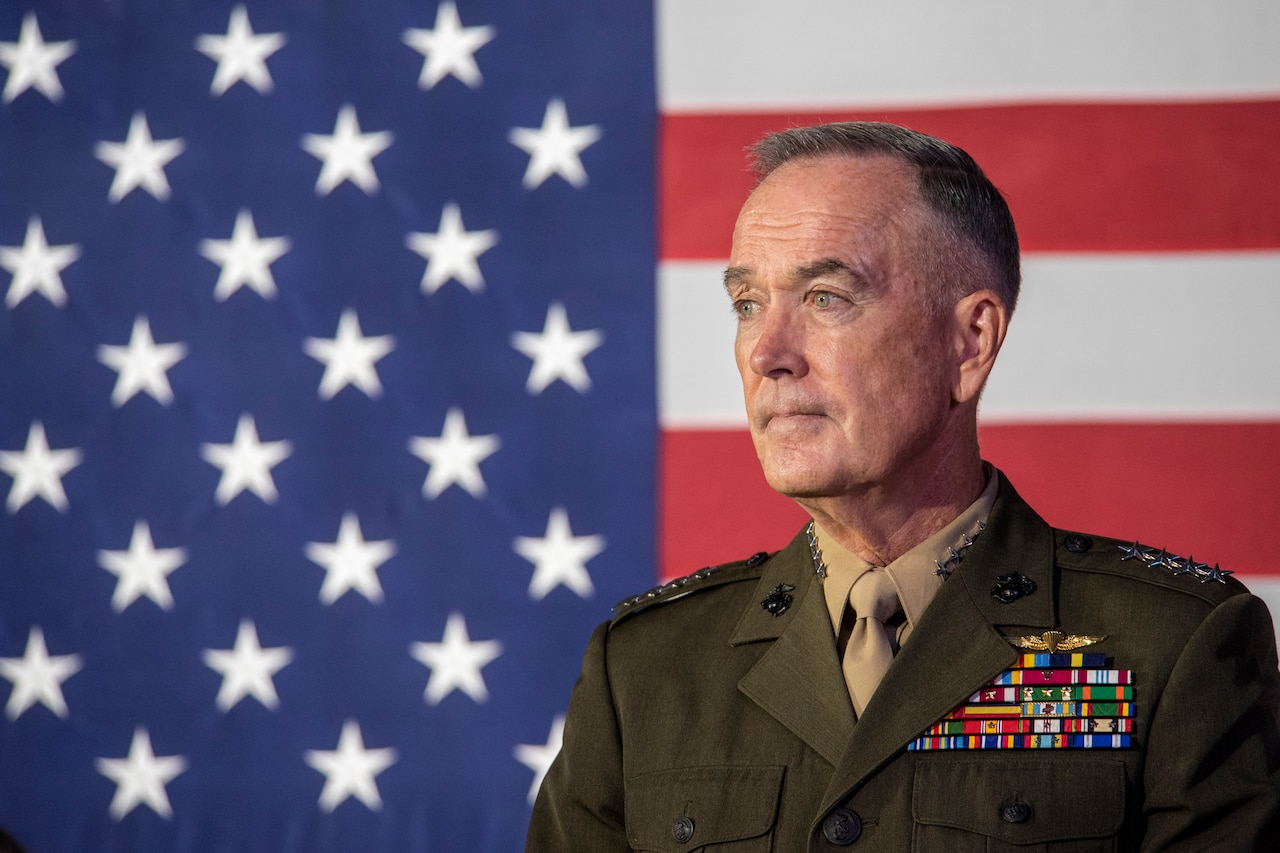 Marine Corps Gen. Joe Dunford, chairman of the Joint Chiefs of Staff,  stands in front of an American flag.