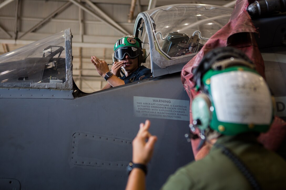 Marine Sgt. Salvatore F. Cuneo and Cpl. Angel J. Garcia, avionics technicians with Marine Attack Training Squadron 203, test communication equipment in the cockpit of an T/AV-8B Harrier II prior to it being moved to outside storage at Marine Corps Air Station Cherry Point, North Carolina, Sep. 16, 2019. Marines attached to VMAT-203 execute daily maintenance to ensure dependability of the aircraft as well as the capability for it be ready at any moment’s notice. VMAT-203 is a part of Marine Aircraft Group 14, 2nd Marine Aircraft Wing.  (U.S. Marine Corps photo by Lance Cpl. Elias E. Pimentel III)