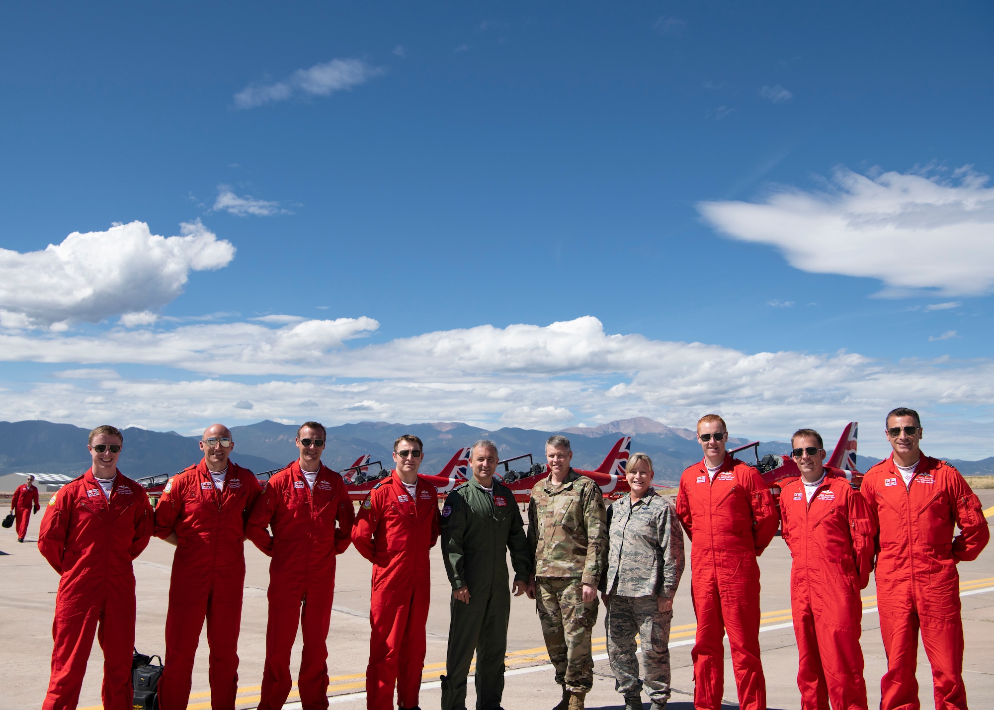 Members of the 21st Space Wing leadership team pose for a photo with members of the Red Arrows, the Royal Air Force aerial demonstration team Sept. 16, 2019 at Peterson Air Force Base, Colorado. The Red Arrows stopped at Peterson AFB as part of their 2019 North American tour. (U.S. Air Force photo by Heather Heiney)