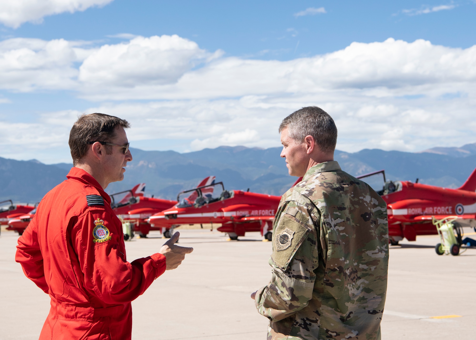 Wing Commander Andrew Keith, left, leader of the Royal Air Force demonstration team, the Red Arrows, speaks with 21st Space Wing vice commander Col. Sam Johnson Sept. 16, 2019 at Peterson Air Force Base, Colorado. The Red Arrows stopped at Peterson AFB as part of their North American tour. (U.S. Air Force photo by Heather Heiney)