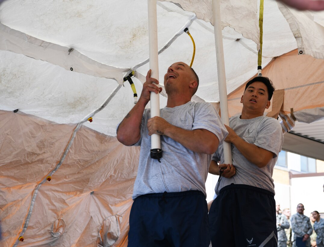 Airmen from the 28th Medical Group set up a decontamination tent during an exercise at Ellsworth Air Force Base, S.D., Sept. 13, 2019. Airmen who participated in the decontamination exercise were timed and graded on their ability to respond to a simulated Chemical, Biological, Radiological and Nuclear threat by donning their hazardous materials suits, setting up a DECON station, and cleaning a training dummy to ensure they were free of any contaminates. (U.S. Air Force photo by Senior Airman Thomas Karol)