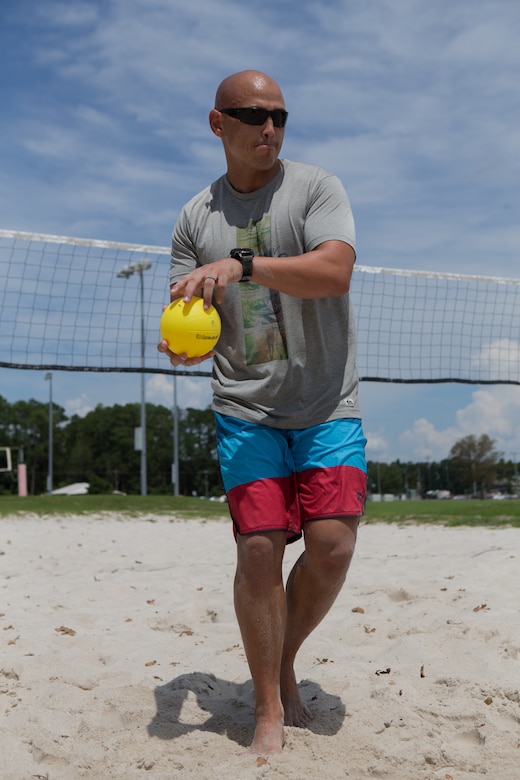Marine Sgt. Maj. Rodney E. Nevinger, Marine Wing Headquarters Squadron 2 sergeant major, prepares to serve the ball during a volleyball game at a unit Family Fun Day at Marine Corps Air Station Cherry Point, North Carolina, August 20, 2019. The Family Fun Day was hosted to give Marines and Sailors an opportunity to socialize and build camaraderie throughout the unit.  (U.S. Marine Corps photo by Pfc. Steven Walls)