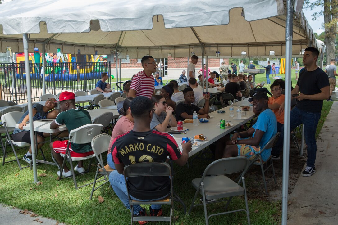 U.S. Marines and Sailors from Marine Wing Headquarters Squadron 2 eat some food during the unit’s Family Fun Day at Marine Corps Air Station Cherry Point, North Carolina, August 20, 2019. The MWHS-2 Family Fun Day was hosted to give Marines and Sailors some time to meet and build camaraderie throughout the unit. (U.S. Marine Corps photo by Pfc. Steven Walls)