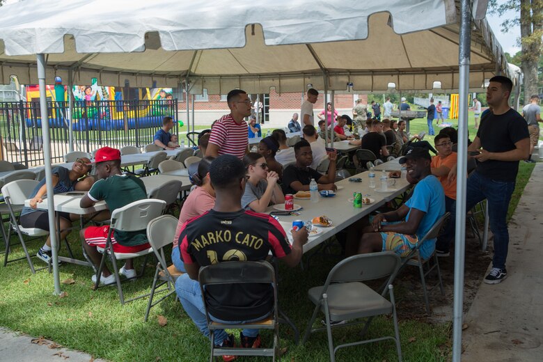 U.S. Marines and Sailors from Marine Wing Headquarters Squadron 2 eat some food during the unit’s Family Fun Day at Marine Corps Air Station Cherry Point, North Carolina, August 20, 2019. The MWHS-2 Family Fun Day was hosted to give Marines and Sailors some time to meet and build camaraderie throughout the unit. (U.S. Marine Corps photo by Pfc. Steven Walls)