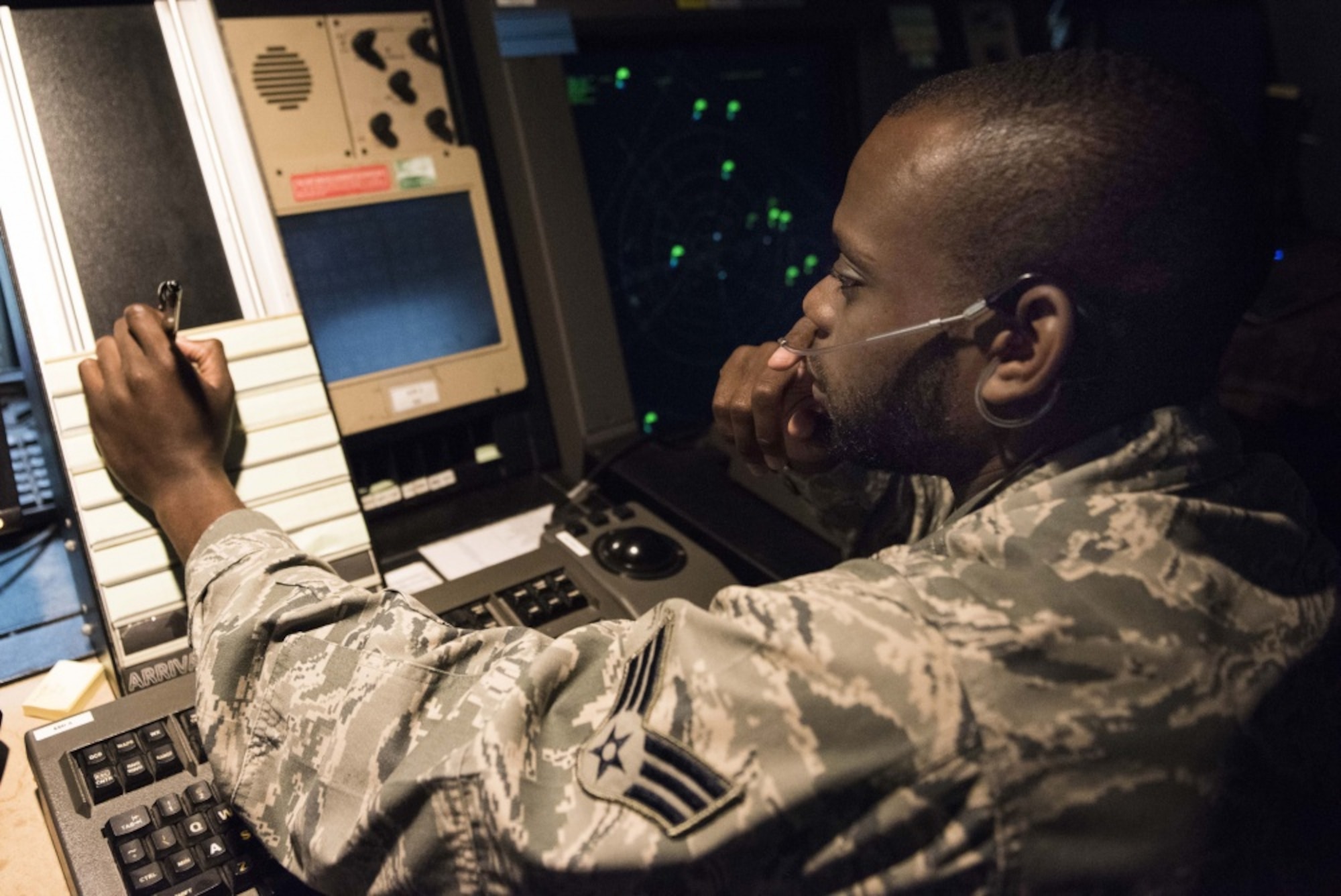 U.S. Air Force Senior Airman Tyler Glass, 39th Operations Support Squadron air traffic controller, communicates with an aircraft in a radar approach and control facility Aug. 9, 2019, at Incirlik Air Base, Turkey. Air traffic controllers are responsible for guiding air traffic and keeping aircraft at a safe distance from one another. (U.S. Air Force photo by Staff Sgt. Joshua Magbanua)