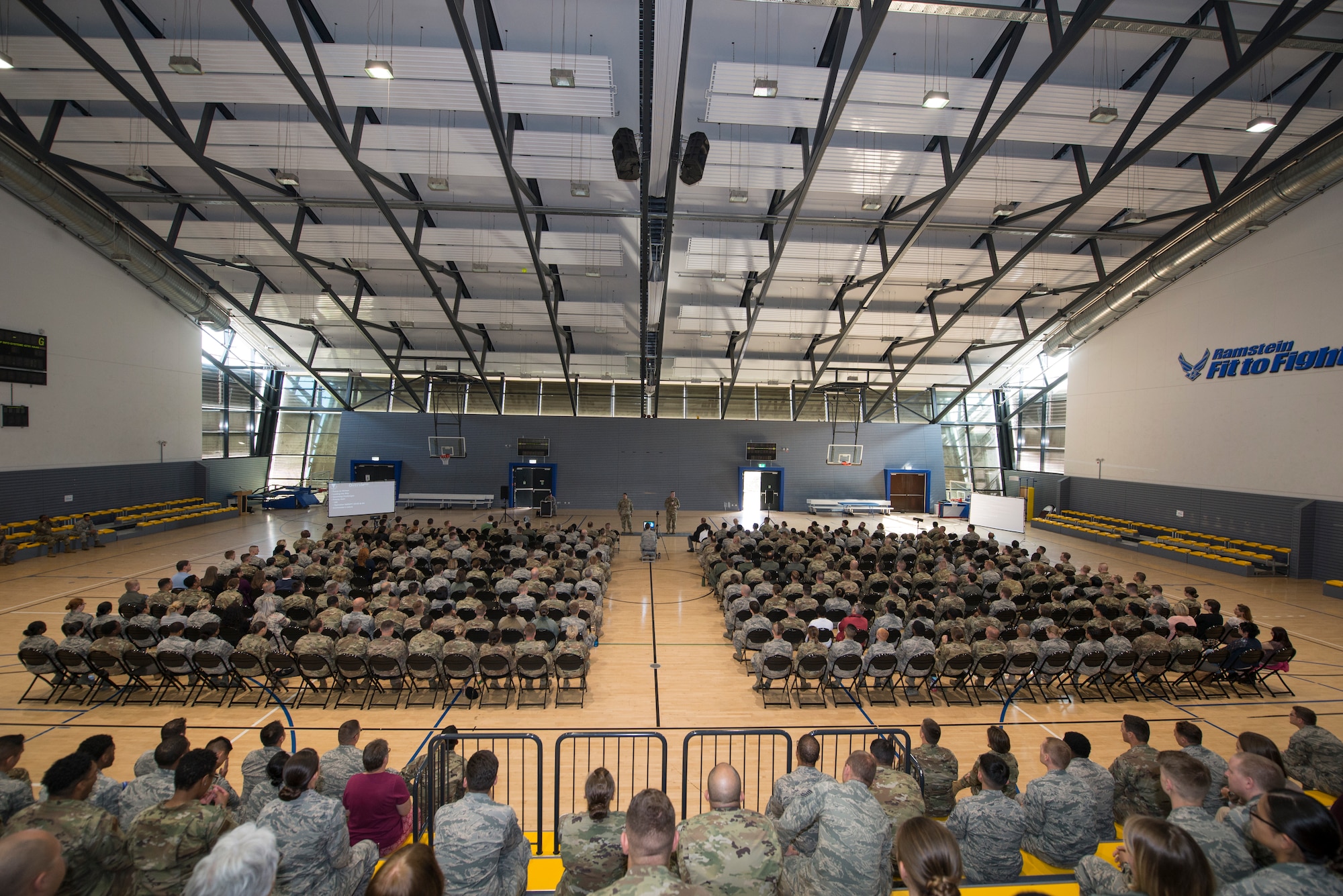 U.S. Air Force Brig. Gen. Mark R. August, 86th Airlift Wing commander, and Chief Master Sgt. Ernesto Rendon, 86th AW command chief, speak to Airmen at an all-call at Ramstein Air Base, Germany, Sept. 17, 2019. August and Rendon discussed accomplishments of the 86th AW in 2019, preparation for Operation Varsity 19-03 and 19-04, and the upcoming Unit Effectiveness Inspection.