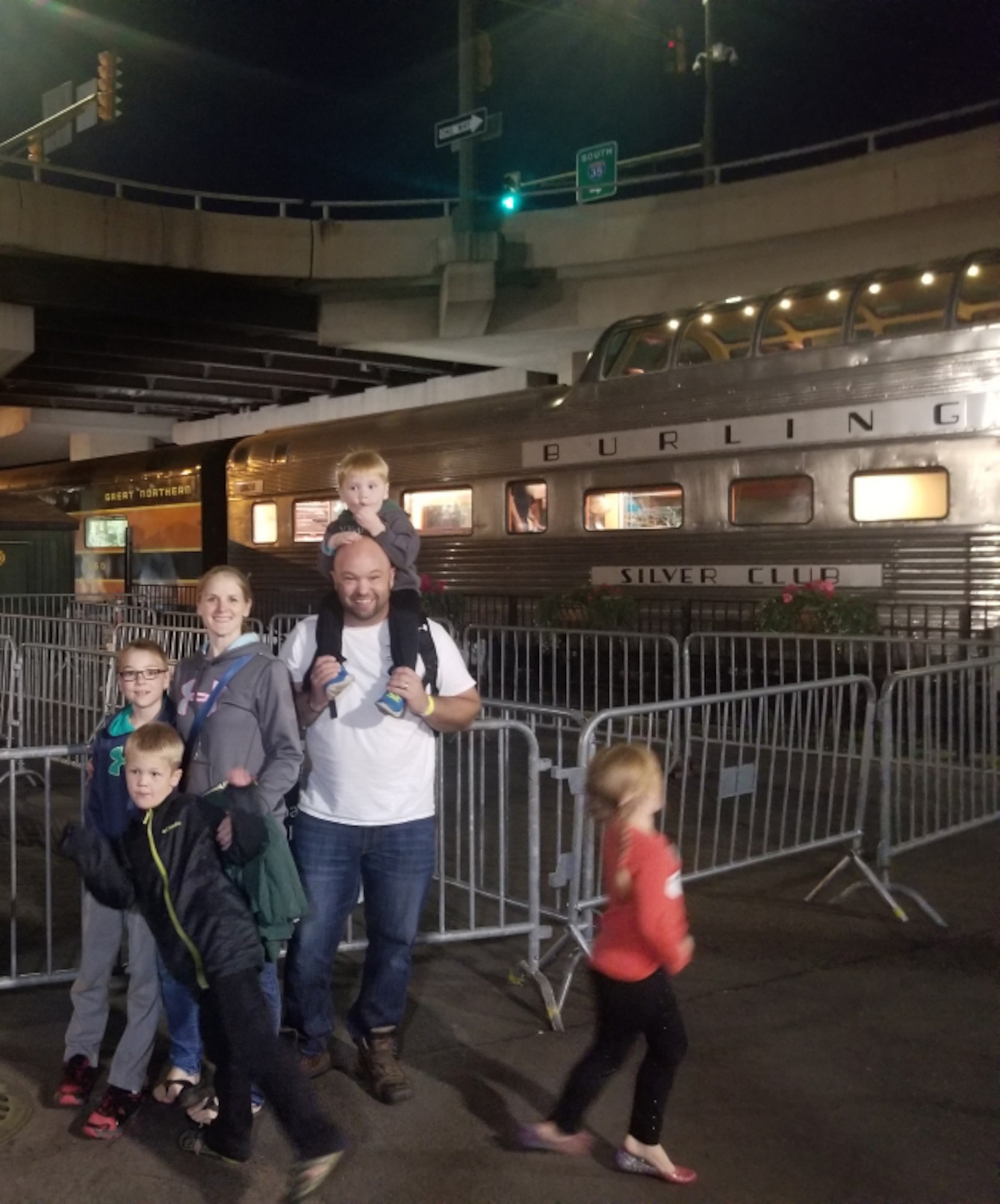 U.S. Air Force Master Sgt. Osten Coaty (right) stands with his family before boarding a dinner train in Duluth, Minnesota, Aug. 28, 2019. During the train ride a driver tried to cross the tracks and was struck causing life threatening injuries, which Coaty responded to. (U.S. Air National Guard photo by Master Sgt. Osten Coaty)