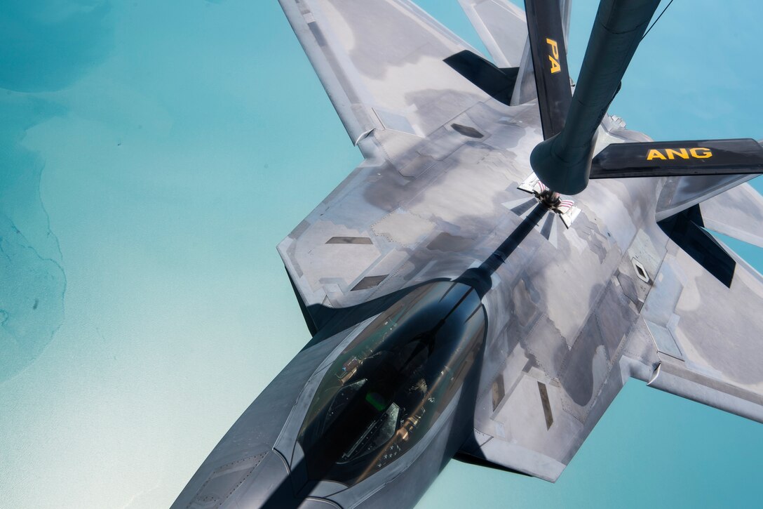 An aircraft receives fuel midair.