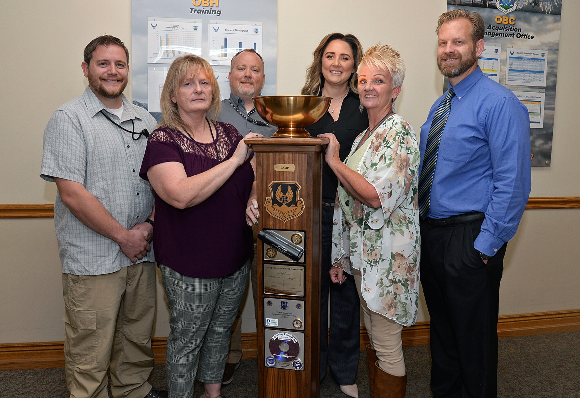 Left to right) Britt Bush, Joan Young, Jacob Beyer, Brittney Starnes, Michelle Broderick and Benjamin Orton, Business Operations Workload Management team, with the Ogden Air Logistics Complex L-A-M-P Award trophy Sept. 10, 2019, at Hill Air Force Base, Utah.