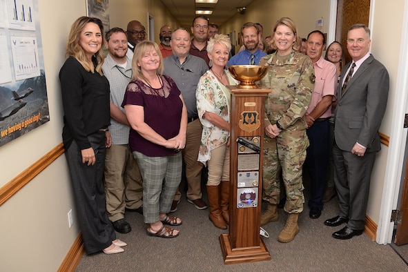 Ogden Air Logistics Complex leadership and the ALC's Business Operations Workload Management team pose with the  L-A-M-P Award trophy Sept. 10, 2019, at Hill Air Force Base, Utah. The award is a traveling trophy presented each month to the ALC’s most outstanding unit or team. (U.S. Air Force photo by Alex R. Lloyd)