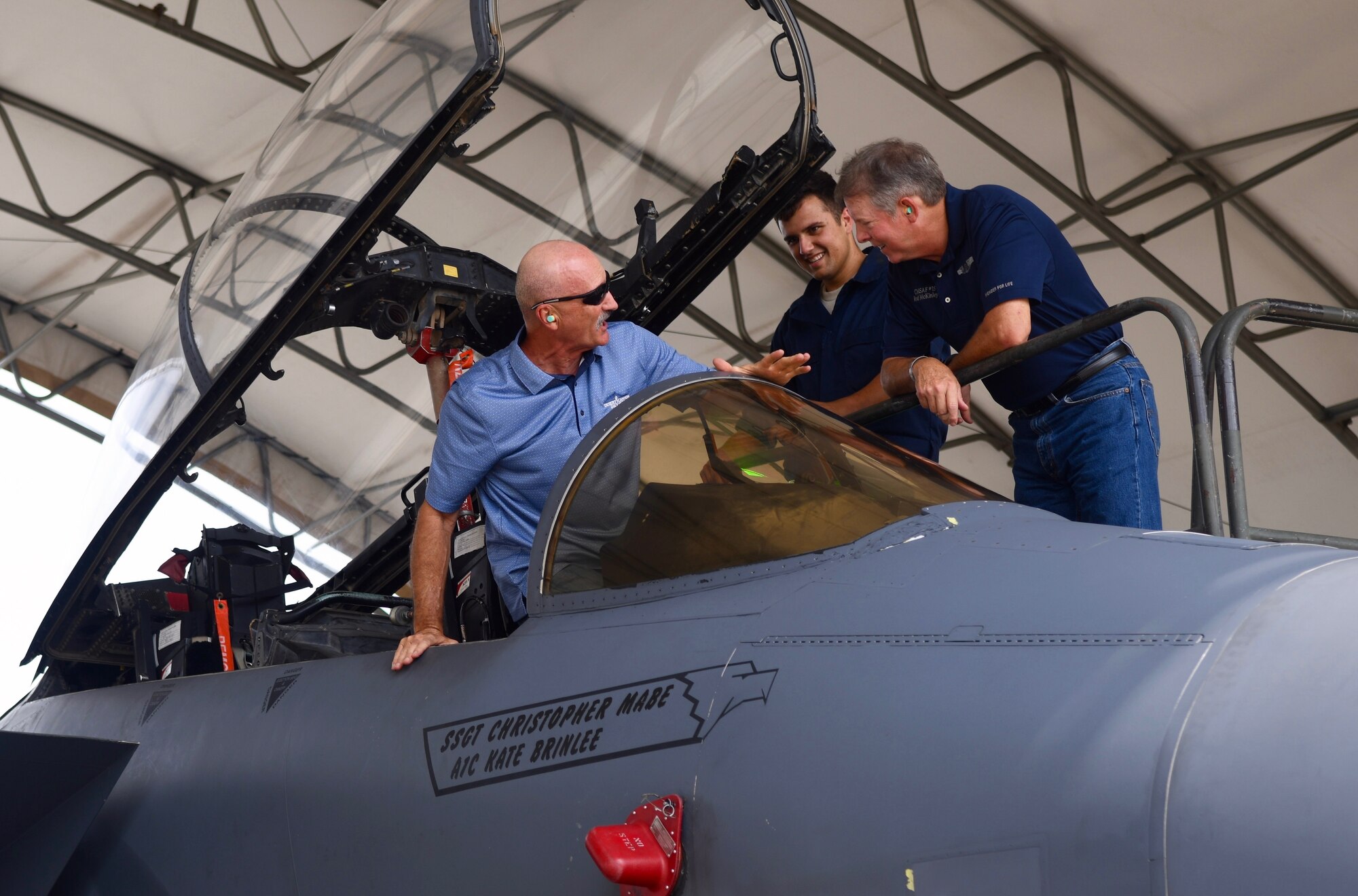 A member of the 4th Aircraft Maintenance Squadron gives the 15th Chief Master Sgt. of the Air Force Rodney McKinley and Ray Iacomacci a tour of an F-15E Strike Eagle Sept. 13, 2019, at Seymour Johnson Air Force Base, North Carolina. Chief McKinley served as the CMSAF from 2006 to 2009. (U.S. Air Force Photo by Staff Sgt. Michael Charles)