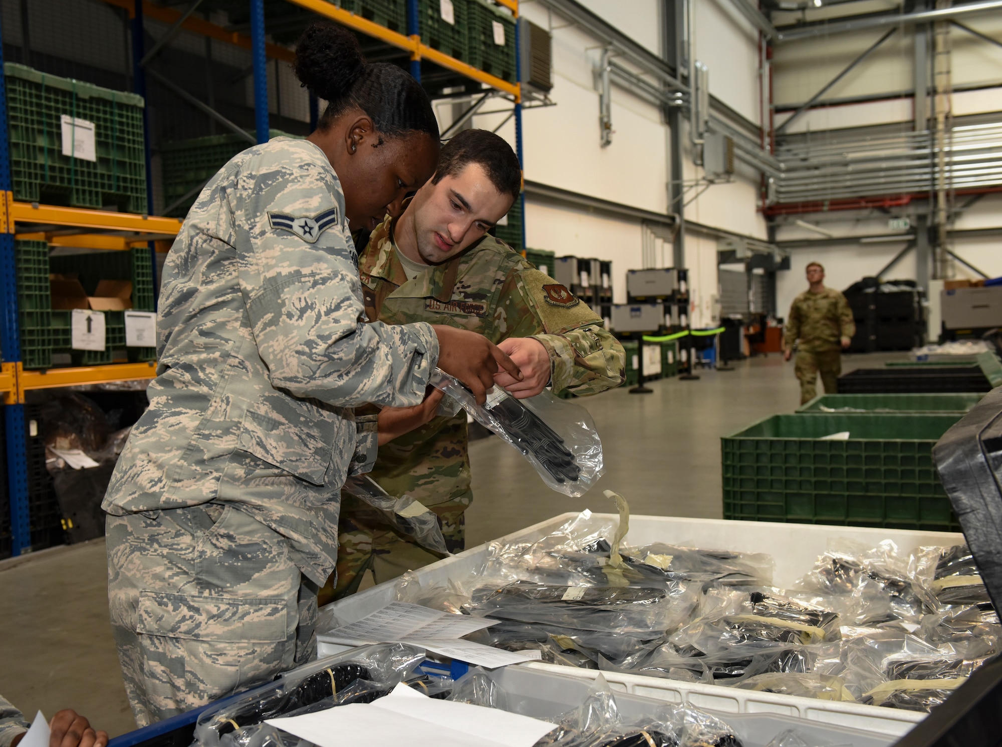 U.S. Air Force Airman 1st Class Zari Washington, 86th Logistics Readiness Squadron hazardous materials journeyman, practices issuing chemical, biological, radiological and nuclear protective training gear to Airman 1st Class Joshua Chittick, 86th LRS Individual Protective Equipment journeyman, at Ramstein Air Base, Germany, Sept. 16, 2019.  The 86th LRS practiced for the 86th Airlift Wing Exercise Operation Varsity 19-03 to test their ability to quickly and effectively issue protective equipment and weapons to emergency essential personnel.