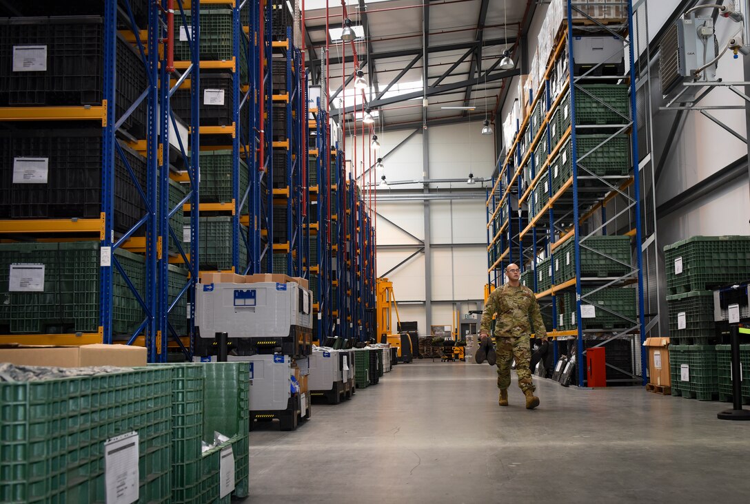 U.S. Staff Sgt. Andrew Ash, 86th Logistics Readiness Squadron noncommissioned officer in charge of Individual Protective Equipment, carries chemical, biological, radiological, nuclear, and explosive material, or CBRNE, protective training boots to an exercise participant at Ramstein Air Base, Germany, Sept. 16, 2019. As the first line of defense in a CBRNE environment, the 86th IPE is preparing for their role in the 86th AW Exercise Operation Varsity 19-03.