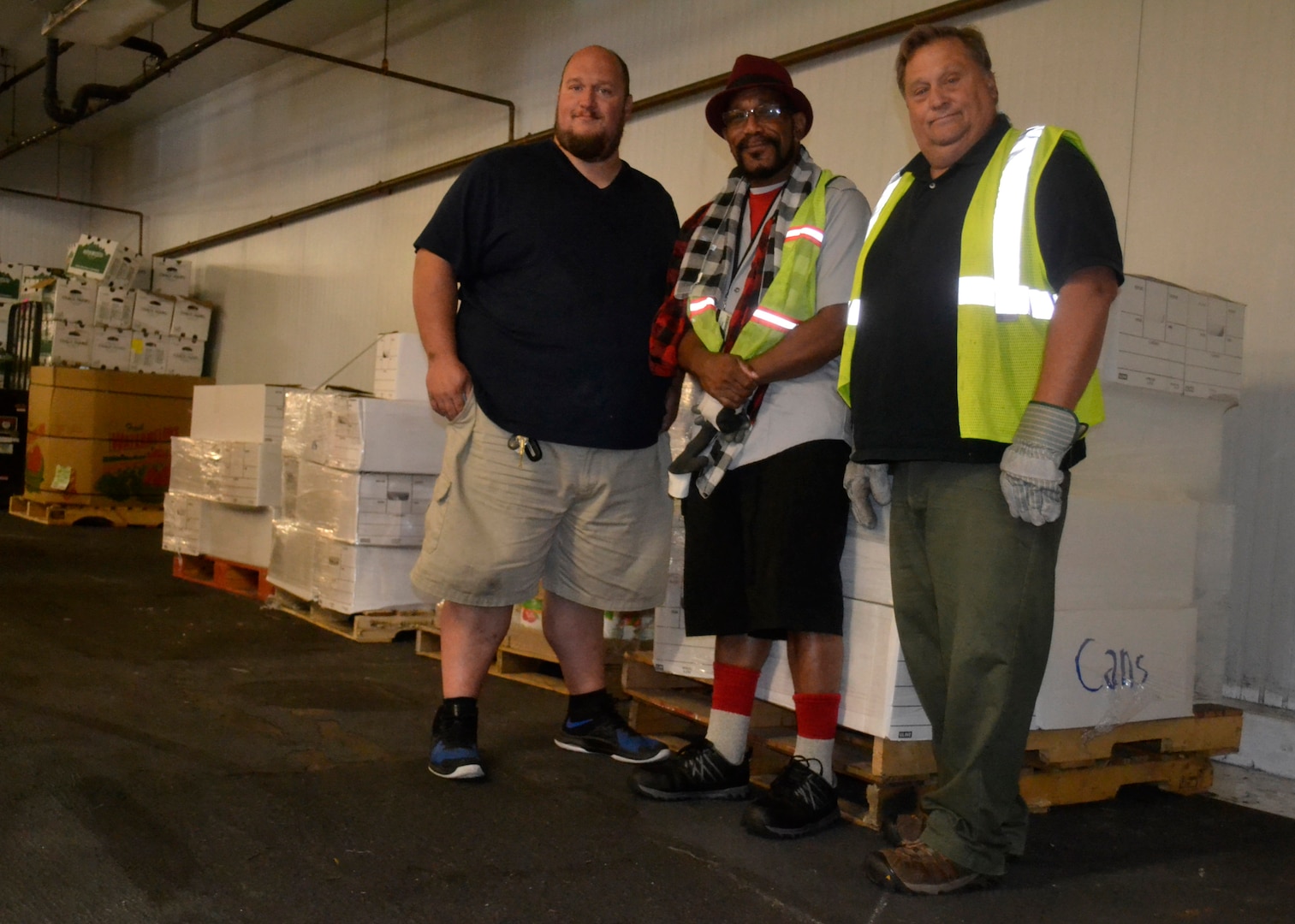 Steve Riecky, a Philabundance warehouse employee, left, and DLA Troop Support material handlers Leonard Shannon, center, and James Burke, right, pose for a photo at the Philabundance warehouse Sept. 13, 2019 in Philadelphia.