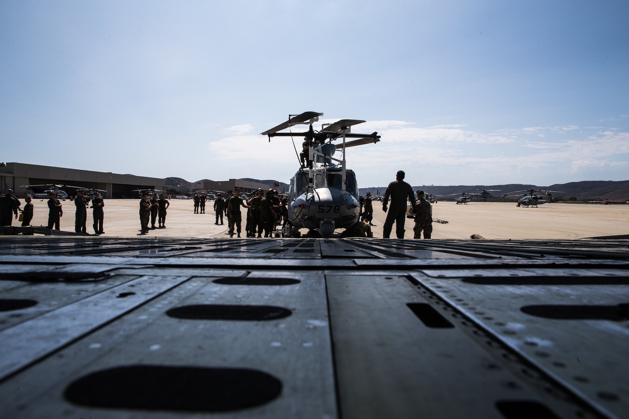 U.S. Marines and airmen assist in loading a UH-1Y Venom into C-5M Super Galaxy at Marine Corps Air Station Camp Pendleton, California, Sept. 16, 2019. The C-5M was a visiting U.S. Air Force aircraft from 433rd Airlift Wing, and was here as part of a dual service training exercise.The air station provides the 1st Marine Expeditionary Force and 3rd Marine Aircraft Wing with flexible deployment options.