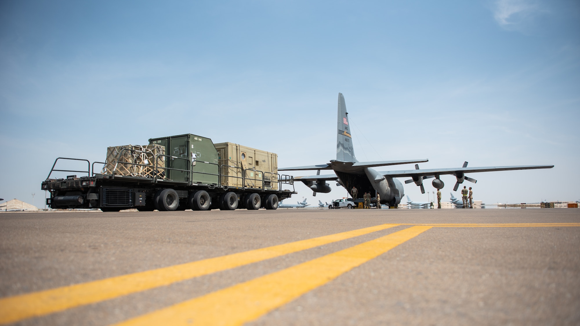 380th Expeditionary Logistics Readiness Squadron air transportation specialists prepare to load a C-130 Hercules Sept. 17, 2019, at Al Dhafra Air Base, United Arab Emirates. The Air Transportation Operations Center enables Airmen to travel and fulfill duty requirements and taskings throughout the area of responsibility. (U.S. Air Force photo by Staff Sgt. Chris Thornbury)