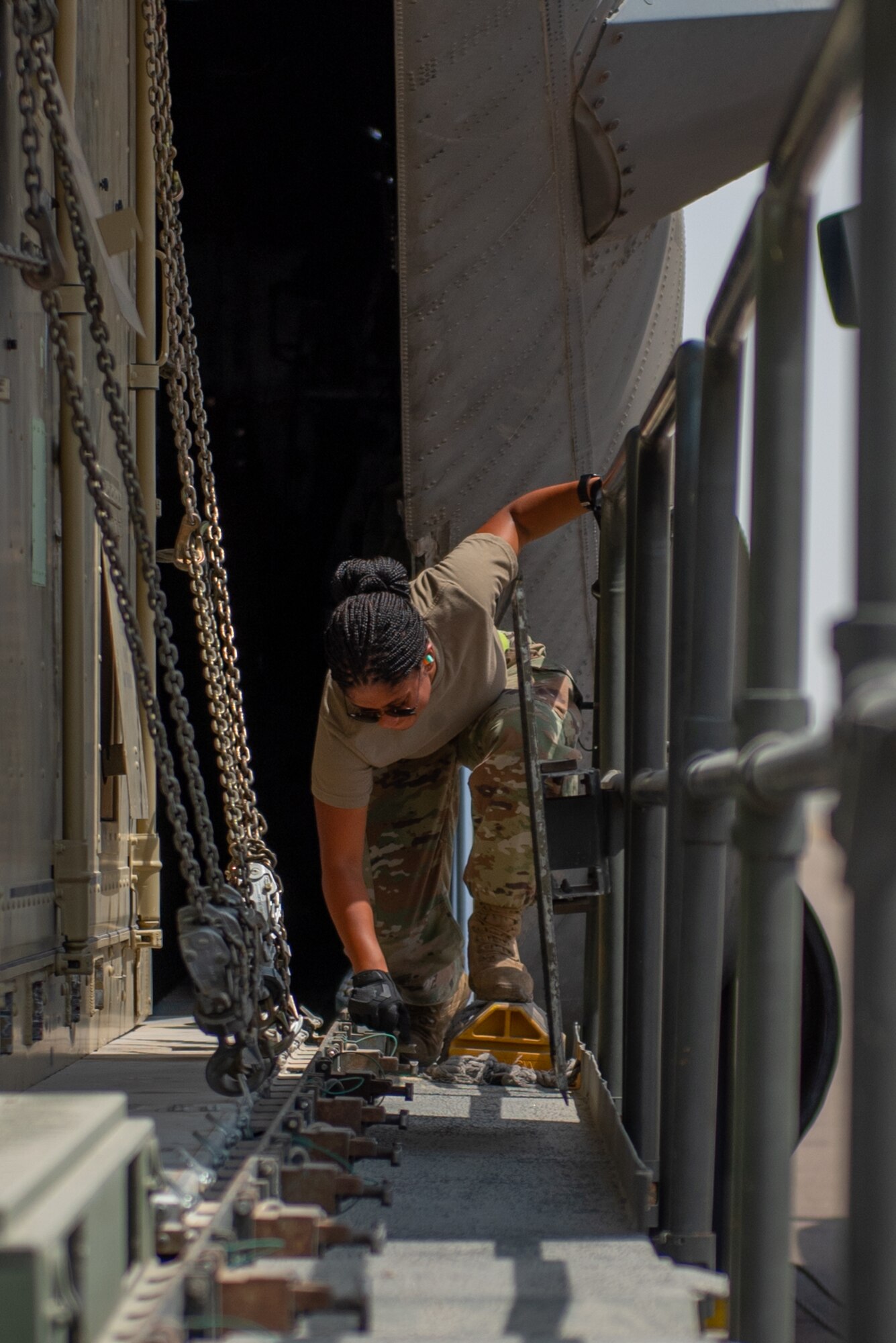 Senior Airman Christa Brantley, 380th Expeditionary Logistics Readiness Squadron air transportation specialist, loosens latches on a K-Loader Sept. 17, 2019, at Al Dhafra Air Base, United Arab Emirates. The Air Transportation Operations Center enables Airmen to travel and fulfill duty requirements and taskings throughout the area of responsibility. (U.S. Air Force photo by Staff Sgt. Chris Thornbury)
