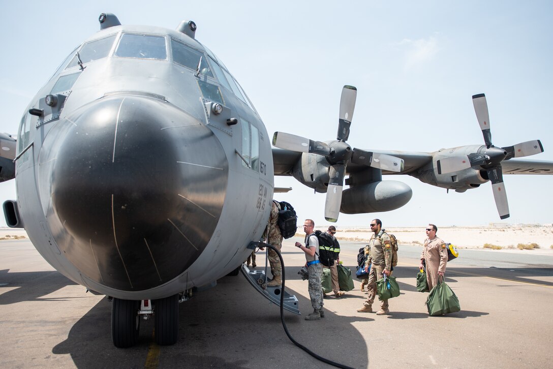 Members of the 336th Expeditionary Fighter Squadron walk up to a C-130 Hercules to forward deploy Sept. 17, 2019, at Al Dhafra Air Base, United Arab Emirates. The unit traveled to Price Sultan Air Base, Saudi Arabia to operate missions and challenge their flexibility at expanding tactical and strategic reach while strengthening coalition and regional partnerships in the Air Forces Central Command area of responsibility. (U.S. Air Force photo by Staff Sgt. Chris Thornbury)