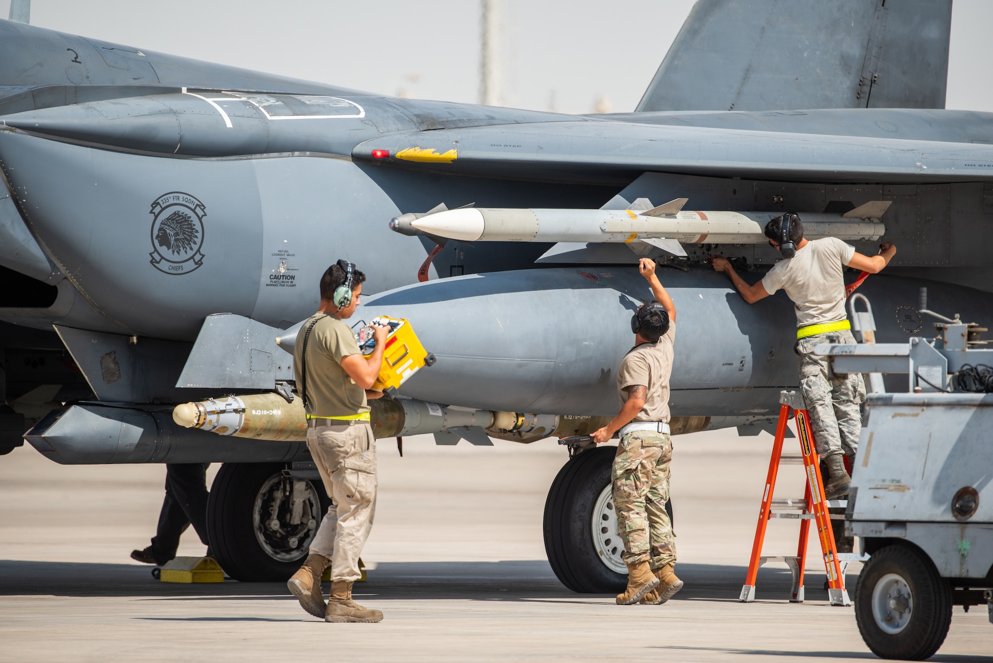 Weapons load crew members arm the munitions on an F-15E Strike Eagle before flight for Agile Strike Sept. 18, 2019, at Al Dhafra Air Base, United Arab Emirates. The 336th EFS sent two aircraft and personnel to operate missions out of Prince Sultan Air Base, Saudi Arabia to challenge their flexibility at expanding tactical and strategic reach while strengthening coalition and regional partnerships in the Air Forces Central Command area of responsibility through adaptive basing. (U.S. Air Force photo by Staff Sgt. Chris Thornbury)
