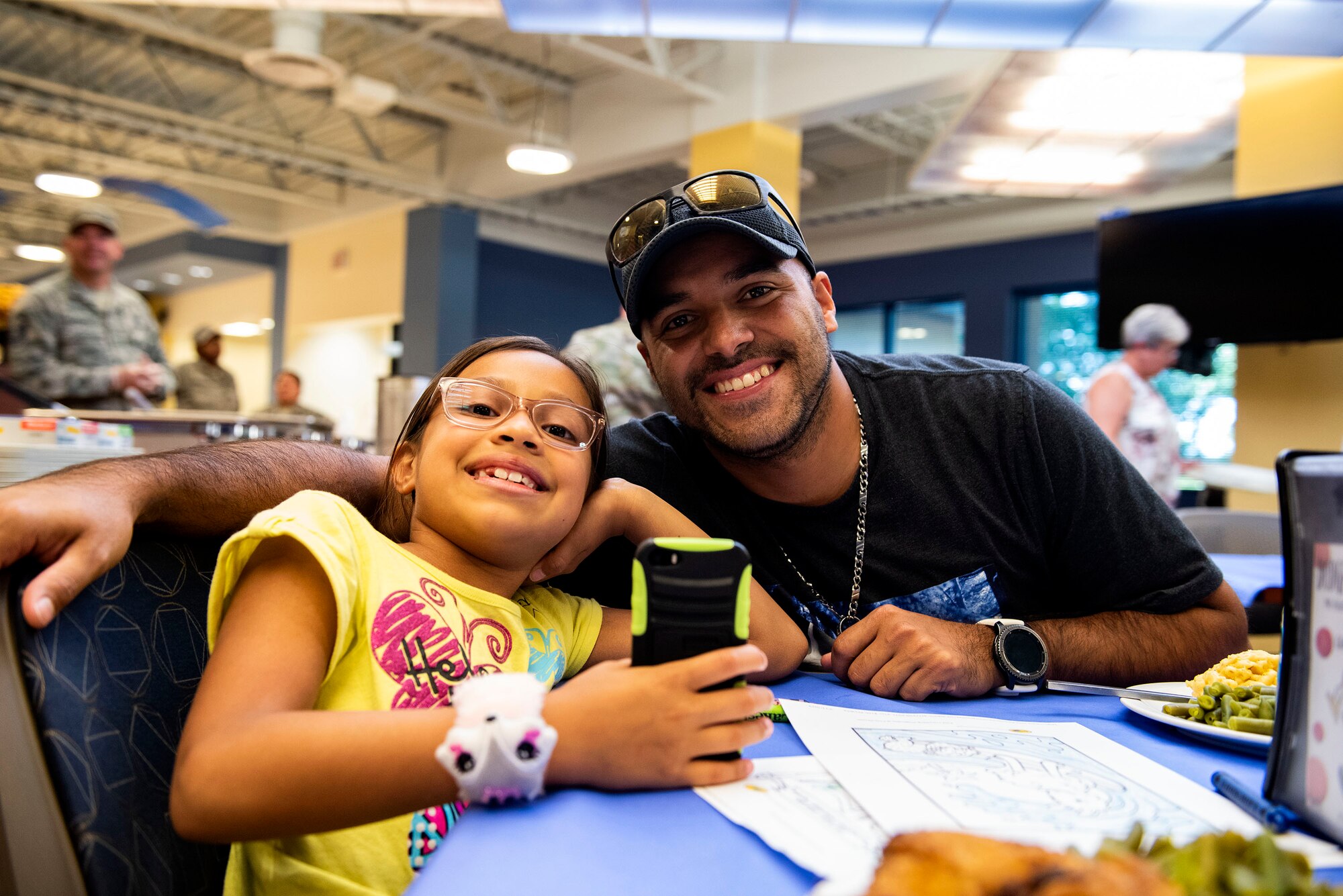 David Garcia, right, military spouse, and his daughter Delena, pose for a photo during a Deployed Spouses Dinner Sept. 17, 2019, at Moody Air Force Base, Ga. The monthly event is a free dinner at Georgia Pines Dining Facility designed as a ‘thank you’ for each families’ support and sacrifice. The dinner, occurring on every third Tuesday of the month, provides an opportunity for spouses to interact with other families of deployed Airmen, key spouses and unit leadership, as well as provide a break for the spouse while military sponsor is deployed. The next Deployed Spouses Dinner will be Oct. 15. (U.S. Air Force photo by Senior Airman Erick Requadt)