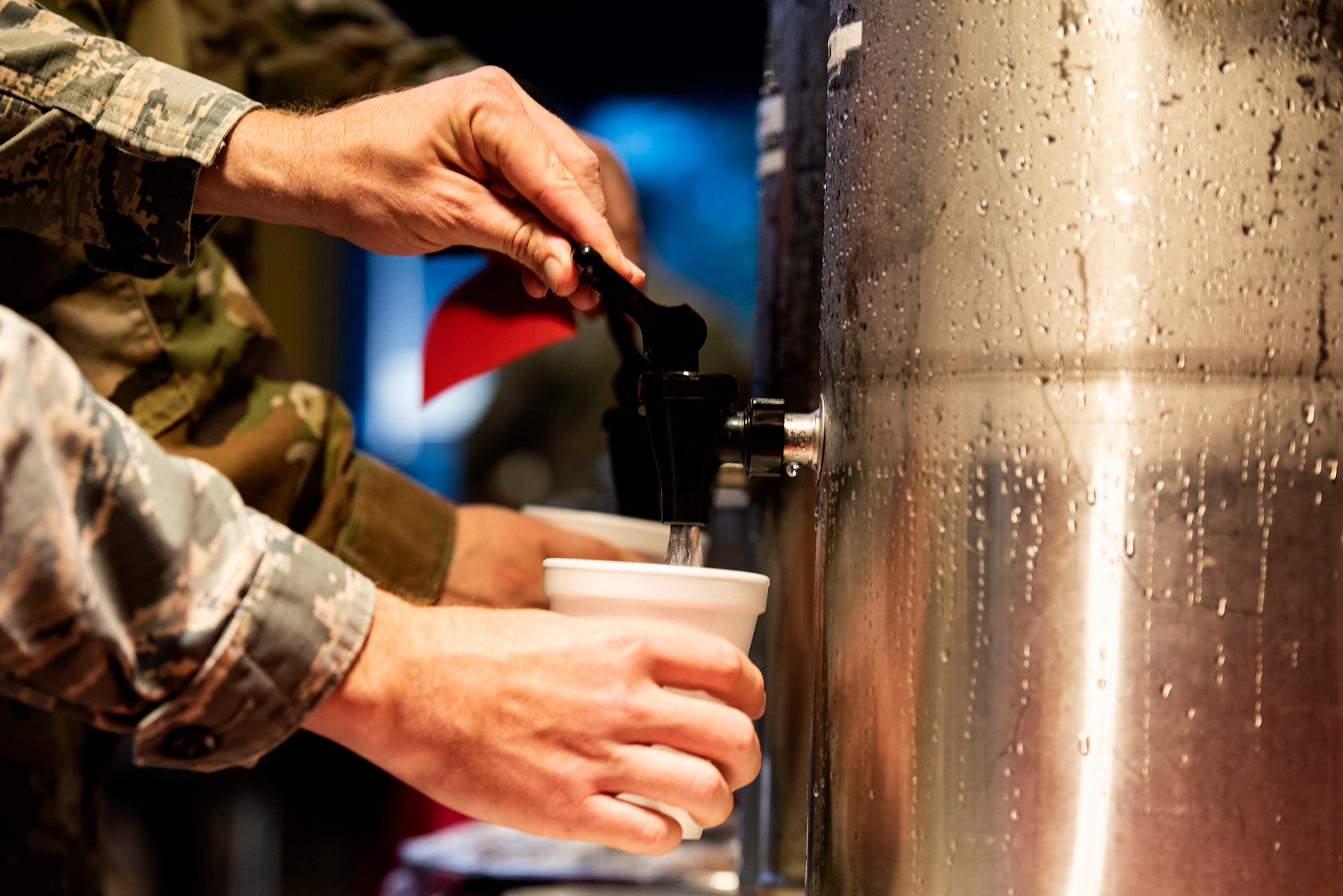 Master Sgt. Brandon Hodges, front, 23d Civil Engineer Squadron (CES) first sergeant, and Lt. Col. Eric Rosenlof, 23d CES commander, pour refreshments for participants during a Deployed Spouses Dinner Sept. 17, 2019, at Moody Air Force Base, Ga. The monthly event is a free dinner at Georgia Pines Dining Facility designed as a ‘thank you’ for each families’ support and sacrifice. The dinner, occurring on every third Tuesday of the month, provides an opportunity for spouses to interact with other families of deployed Airmen, key spouses and unit leadership, as well as provide a break for the spouse while military sponsor is deployed. The next Deployed Spouses Dinner will be Oct. 15. (U.S. Air Force photo by Senior Airman Erick Requadt)