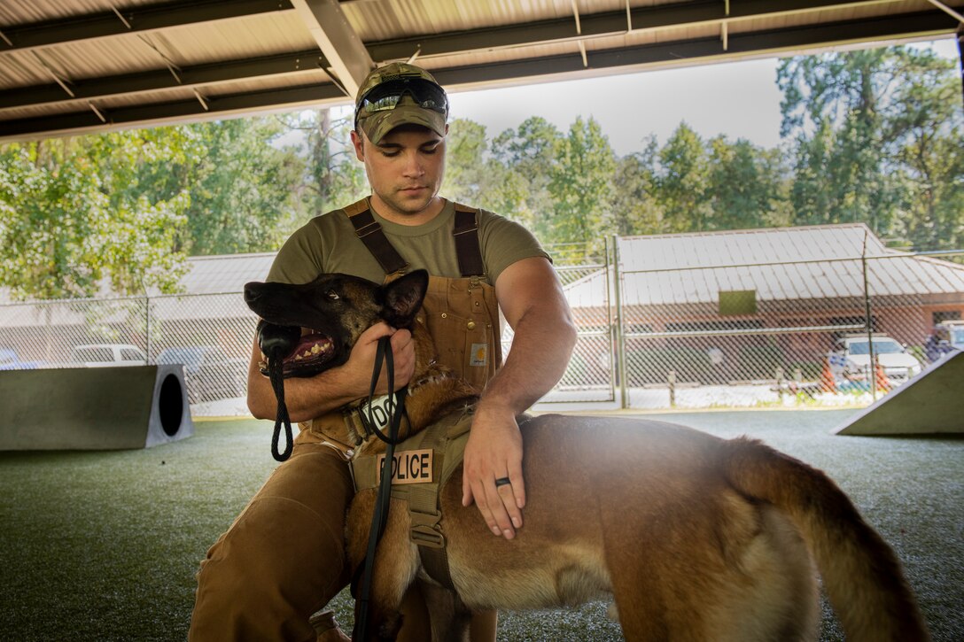 Senior Airman Steven Goff III, 23d Security Forces Squadron military working dog (MWD) handler, pets MWD Ttoby, after a training demonstration, Aug. 29, 2019, at Moody Air Force Base, Ga. Goff recently became a part of the K-9 unit and is currently in the process of completing his validation training. (U.S. Air Force photo by Airman Elijah M. Dority)