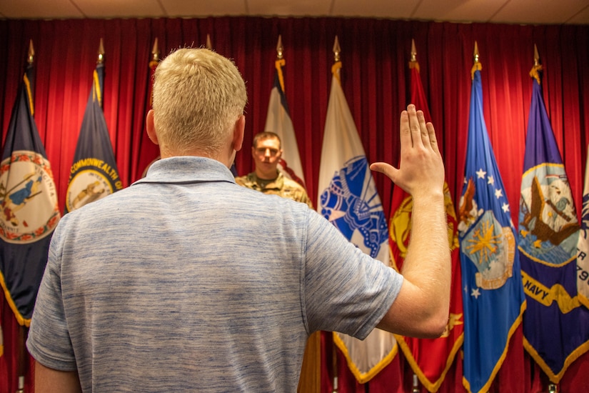 Pvt. 1st Class Michael Winter recites the Oath of Enlistment at the MEPS, in Beckley, West Virginia.