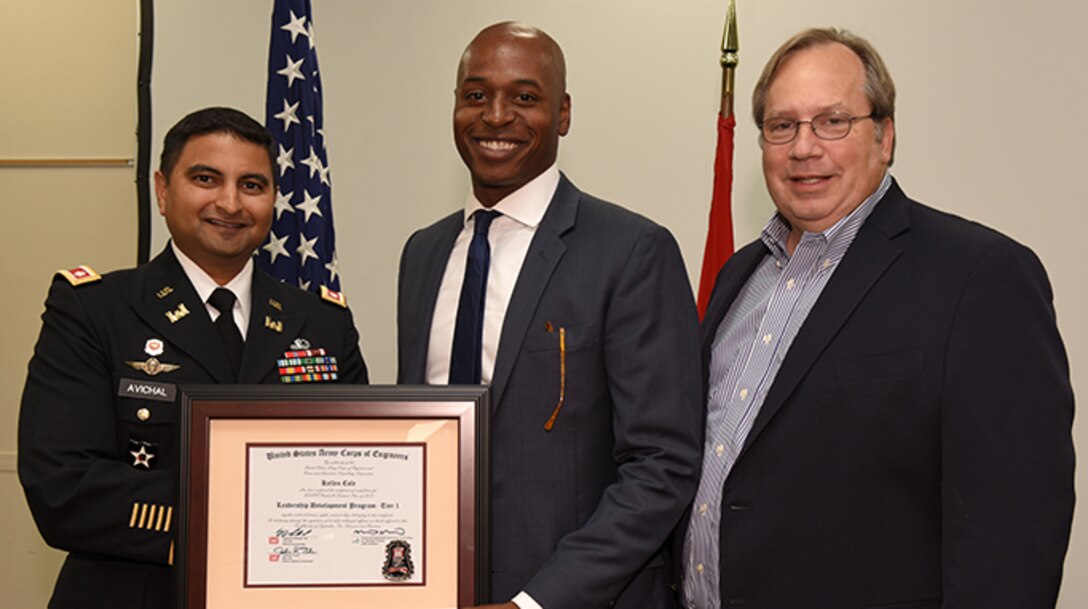 Kellen Cole, U.S. Army Corps of Engineers Nashville District, receives a certificate of completion for the 2019 Leadership Development Program Level I Course from Lt. Col. Sonny B. Avichal, Nashville District commander, and Michael Evans, course instructor, during a graduation ceremony Sept. 12, 2019 at the Scarritt Bennett Center in Nashville, Tenn. (USACE Photo by Lee Roberts)