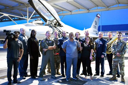 Members from Joint Base San Antonio-Lackland pose for a group photo in front of an F-16 Fighting Falcon, an aircraft sssigned to the 149th Fighter Wing, with local weather reporters Sept. 18 at JBSA-Kelly Field Annex in honor of the Air Force’s 72nd birthday.