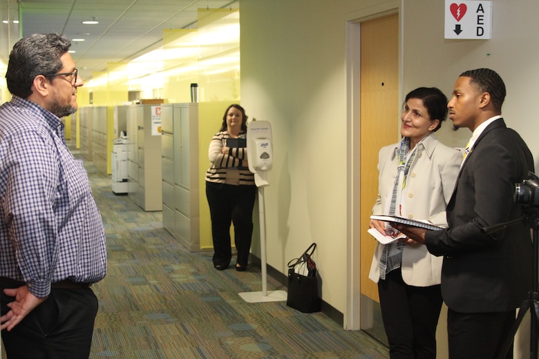 David Best, contract specialist, Kansas City District, U.S. Army Corps of Engineers, left, answers questions from Dr. Fara Zakery, dean of the Anheuser-Busch School of Business at Harris-Stowe State University, and senior student majoring in business, Adam Haley, September 18, 2019. Harris-Stowe is creating a Contracting Professionals Recruiting Program which will include marketing materials for the Kansas City District under contract. Gwendolyn Miller, chief of the Contracting Division, watches from the background.