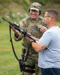 Jerry Anthis, a service manager for Sinclair Fuel on Long Island, gets hints about the M-4 carbine from New York Army National Guard Sgt. 1st Class Fredrick Goldacker during a "boss lift" at Camp Smith Training Site in Cortlandt Manor, N.Y. on Monday, Sept. 16, 2019.