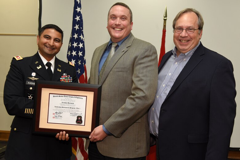 Jonathan Bartusiak, U.S. Army Corps of Engineers Nashville District, receives a certificate of completion for the 2019 Leadership Development Program Level I Course from Lt. Col. Sonny B. Avichal, Nashville District commander, and Michael Evans, course instructor, during a graduation ceremony Sept. 12, 2019 at the Scarritt Bennett Center in Nashville, Tenn. (USACE Photo by Lee Roberts)