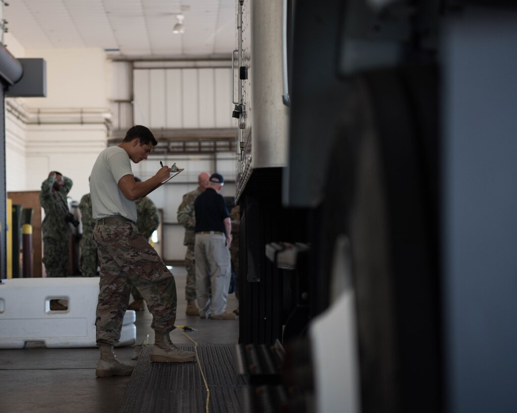 U.S.  Air Force Airman 1st Class Jaxson Doyle, 733rd Logistics Readiness Squadron small air terminal specialist, inspects a vehicle during a Joint Task Force Civil Support exercise at Joint Base Langley-Eustis, Virginia, Sept. 11, 2019. Members of the terminal were tasked with inspecting the internal and external contents of the vehicles before approving them to be transported via a U.S. Air Force C-17 Globemaster III from the Mississippi Air National Guard’s 172nd Airlift Wing, to Richmond, Virginia. (U.S. Air Force photo by Airman 1st Class Marcus M. Bullock)