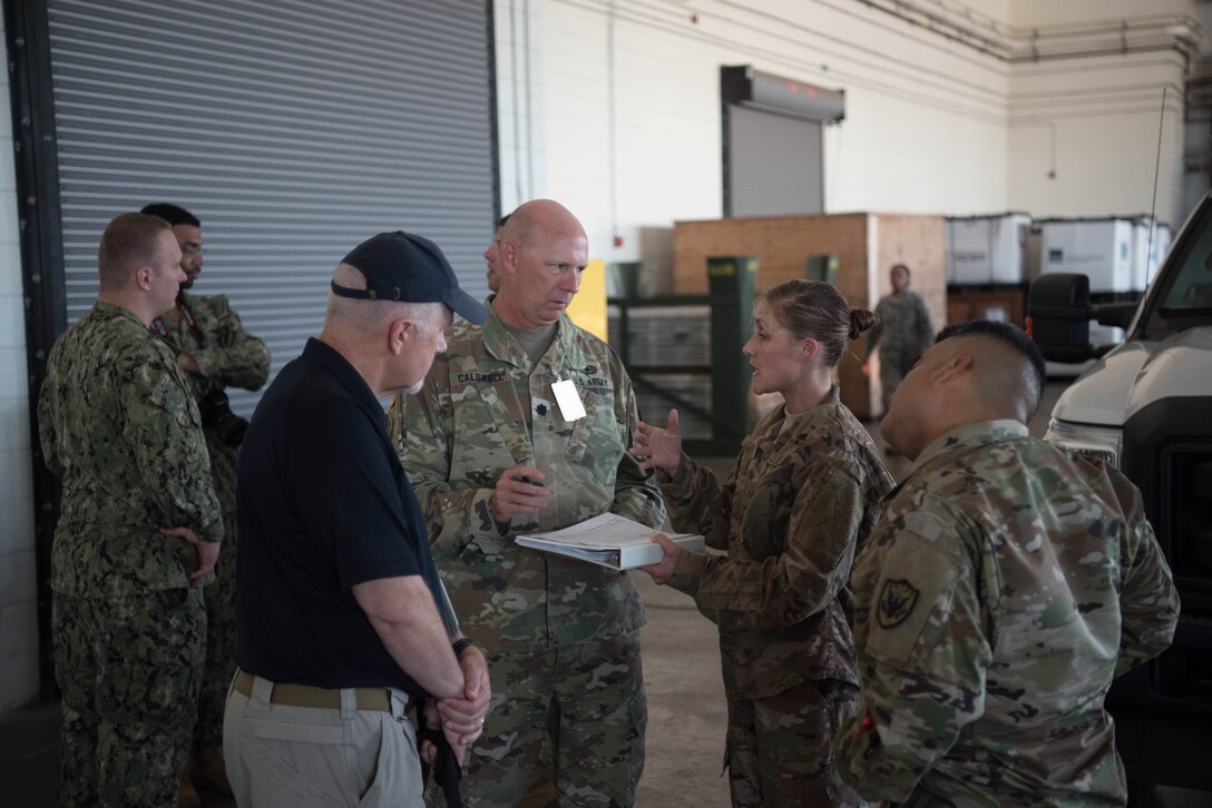Members of the U.S. Air Force, Army, and Navy discuss inspection and transportation of vehicles in the small air terminal during a Joint Task Force Civil Support exercise at Joint Base Langley-Eustis, Virginia, Sept. 11, 2019. Multiple branches of the U.S. armed forces participated in this exercise to help prepare their organizations for real world scenarios. (U.S. Air Force photo by Airman 1st Class Marcus M. Bullock)