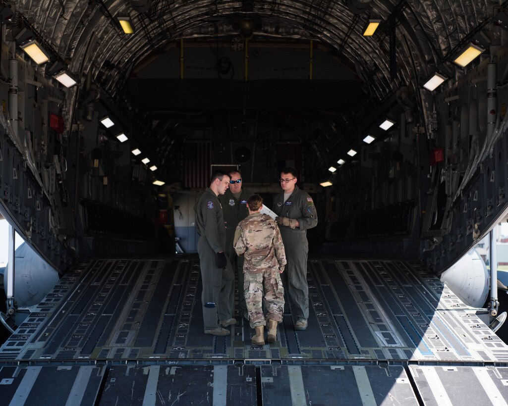 Members of the U.S. Air Force discuss placement of cargo on the ramp of a U.S. Air Force C-17 Globemaster III from the Mississippi Air National Guard’s 172nd Airlift Wing during a Joint Task Force Civil Support exercise at Joint Base Langley-Eustis, Virginia, Sept. 11, 2019. Members of the C-17 crew were tasked with transporting cargo to Richmond, Virginia during the two-day exercise. (U.S. Air Force photo by Airman 1st Class Marcus M. Bullock)