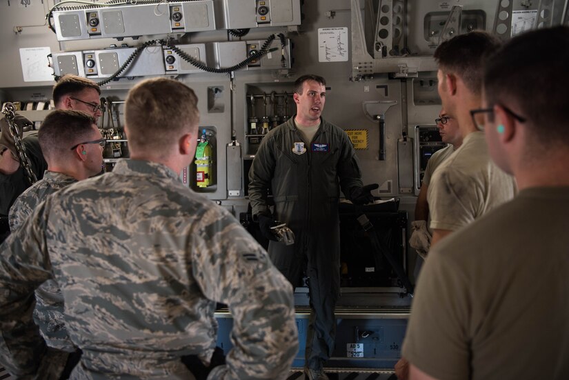 U.S. Air Force Airmen discuss how cargo for a U.S. Air Force C-17 Globemaster III from the Mississippi Air National Guard’s 172nd Airlift Wing is going to be loaded and strapped for a flight during a Joint Task Force Civil Support exercise at Joint Base Langley-Eustis, Virginia, Sept. 11, 2019. The C-17 crew members showed Airmen at JBLE how to properly secure cargo to help improve their real world readiness capabilities. (U.S. Air Force photo by Airman 1st Class Marcus M. Bullock)