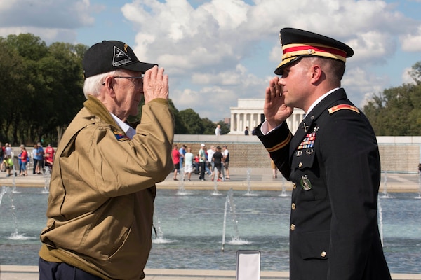 Army Maj. Peter Semanoff salutes World War II veteran Clarence Smoyer