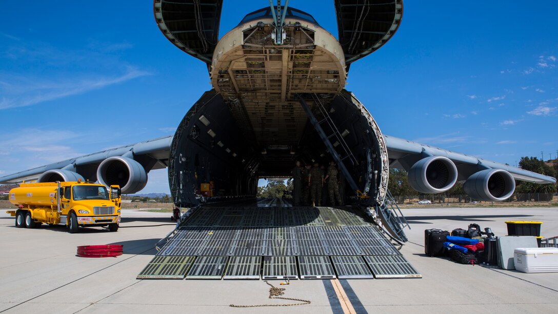 A U.S. Air Force C-5M Super Galaxy opens its hatch in preparation to load a U.S. Marine Corps UH-1Y Venom on Marine Corps Air Station Camp Pendleton, Calif., Sept. 16, 2019. The C-5M was a part of the U.S. Air Forces 433rd Air Lift Wing and was visiting 3rd Marine Aircraft Wing (MAW) in preparation for NATO Day in the Czech Republic. (U.S. Marine Corps photo by Cpl. Levi J. Guerra)