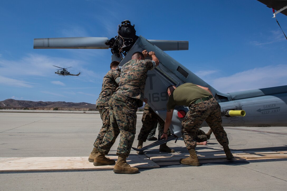 U.S. Marines with Marine Light Attack Training Squadron 303, Marine Aircraft Group 39, 3rd Marine Aircraft Wing (MAW), loads a U.S. Marine Corps UH-1Y Venom on a U.S. Air Force C-5M Super Galaxy on Marine Corps Air Station Camp Pendleton, Calif., Sept. 16, 2019. The C-5M was a part of the U.S. Air Forces 433rd Air Lift Wing and was visiting 3rd MAW in preparation for NATO Day in the Czech Republic. (U.S. Marine Corps photo by Cpl. Levi J. Guerra)