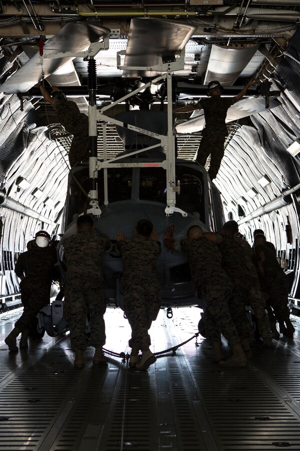 U.S. Marines with Marine Light Attack Training Squadron 303, Marine Aircraft Group 39, 3rd Marine Aircraft Wing (MAW), loads a U.S. Marine Corps UH-1Y Venom on a U.S. Air Force C-5M Super Galaxy on Marine Corps Air Station Camp Pendleton, Calif., Sept. 16, 2019. The C-5M was a part of the U.S. Air Forces 433rd Air Lift Wing and was visiting 3rd MAW in preparation for NATO Day in the Czech Republic. (U.S. Marine Corps photo by Cpl. Levi J. Guerra)