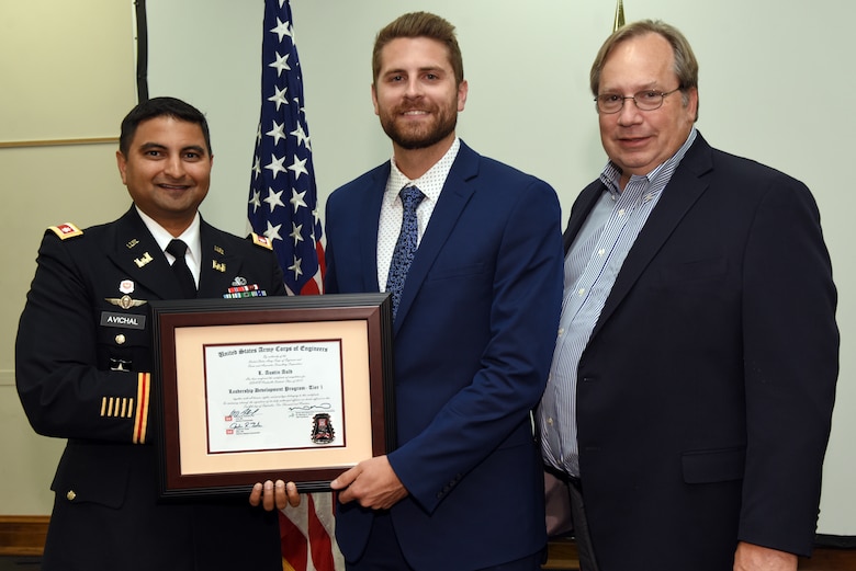 Austin Auld, U.S. Army Corps of Engineers Nashville District, receives a certificate of completion for the 2019 Leadership Development Program Level I Course from Lt. Col. Sonny B. Avichal, Nashville District commander, and Michael Evans, course instructor, during a graduation ceremony Sept. 12, 2019 at the Scarritt Bennett Center in Nashville, Tenn. (USACE Photo by Lee Roberts)