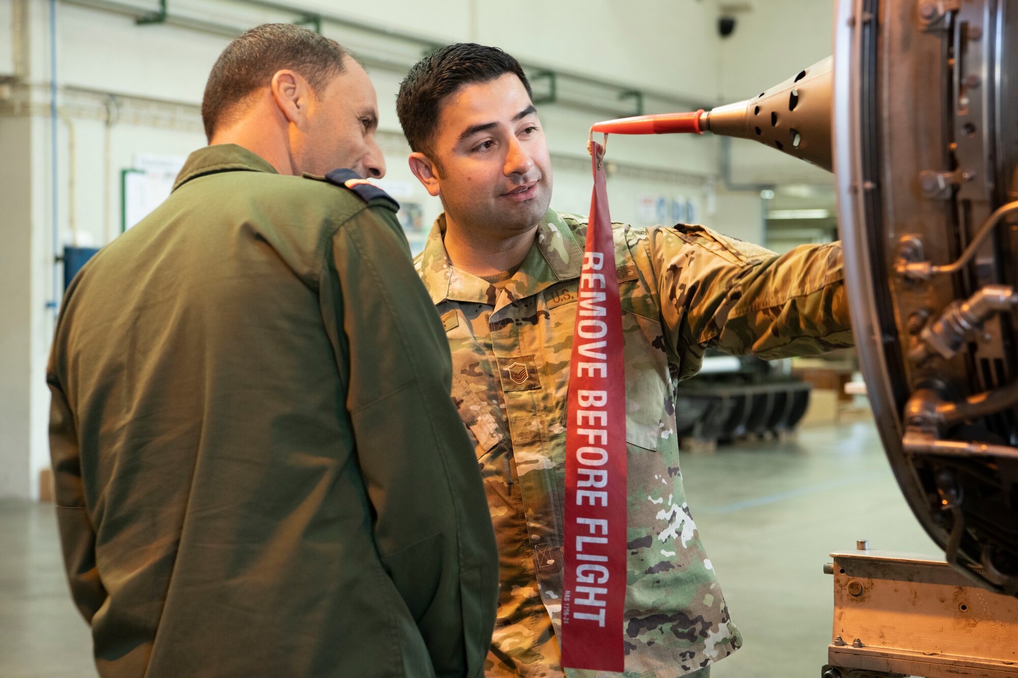 U.S. Air Force Master Sgt. Eric Morales, production superintendent, assigned to the 721st Aircraft Maintenance Squadron, Ramstein Air Base, Germany, observes Portuguese aircraft parts with a member of the European Partnership Flight at Monte Real Air Base, Portugal, Sept. 10, 2019. The European Partnership Flight serves as an opportunity for the U.S. and partner nations to share best practices, strengthen relationships, and build trust. (U.S. Army photo by Specialist Catessa Palone)