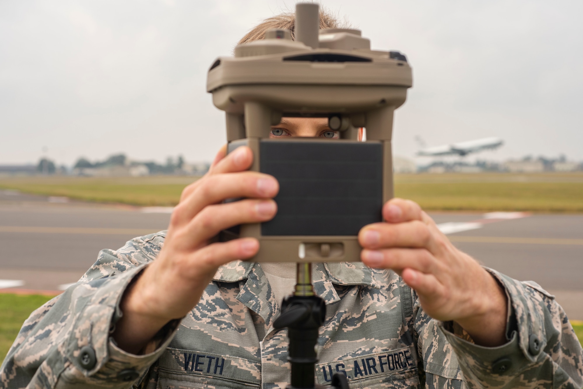 U.S. Air Force Airman 1st Class Adam Vieth, 100th Operations Support Squadron weather forecaster apprentice, secures the micro weather sensor on a tripod Sept. 10, 2019, at RAF Mildenhall, England.  Airmen can access the data the micro weather sensor collects anywhere they have an internet connection and Common Access Card reader.  (U.S. Air Force photo by Airman 1st Class Joseph Barron)