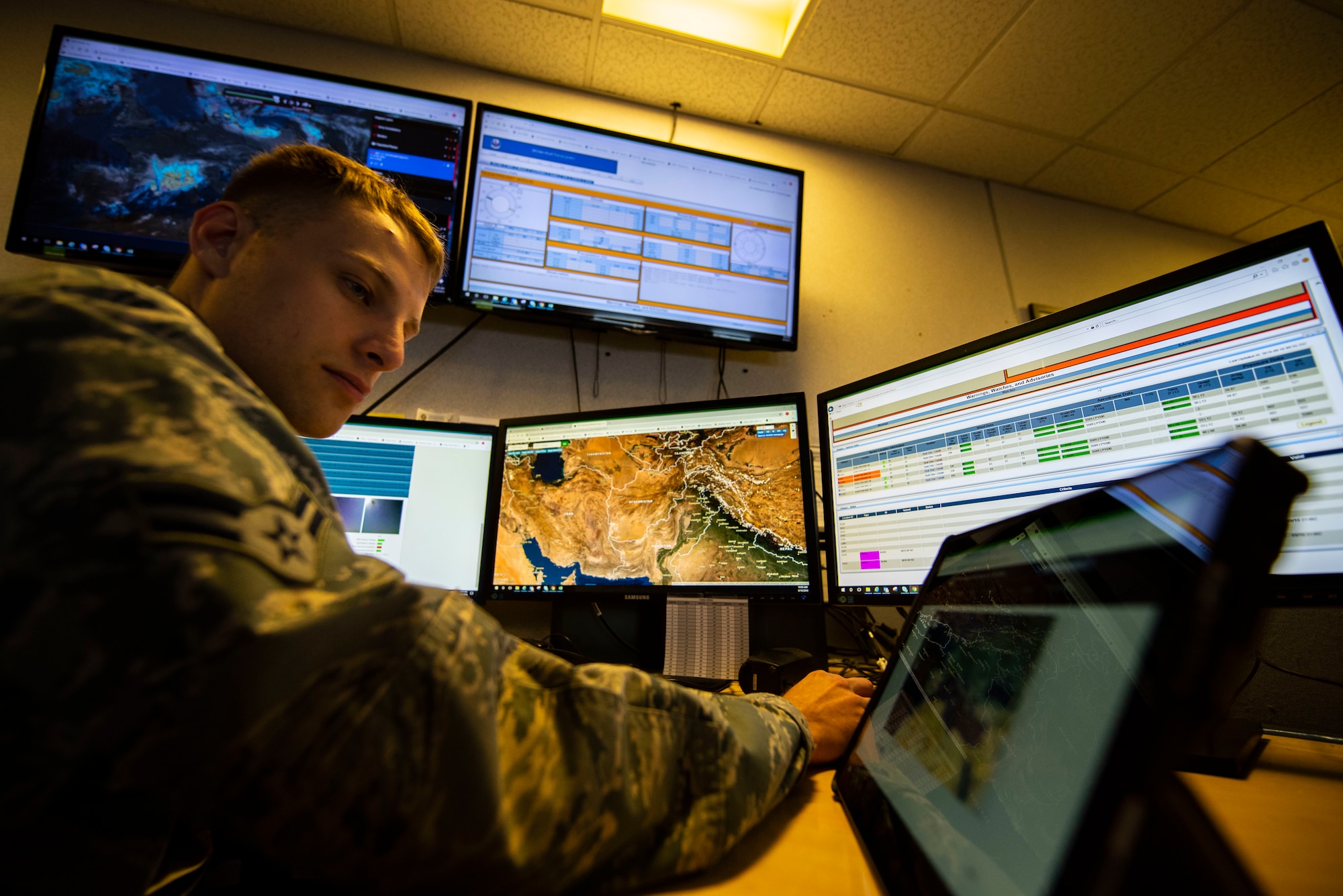 U.S. Air Force Airman 1st Class Adam Vieth, 100th Operations Support Squadron weather forecaster apprentice, examines current weather conditions Sept. 10, 2019, at RAF Mildenhall, England. The weather flight produces forecasts in order to put out weather watches, warnings and advisories to support resource and personnel protection. (U.S. Air Force photo by Airman 1st Class Joseph Barron)