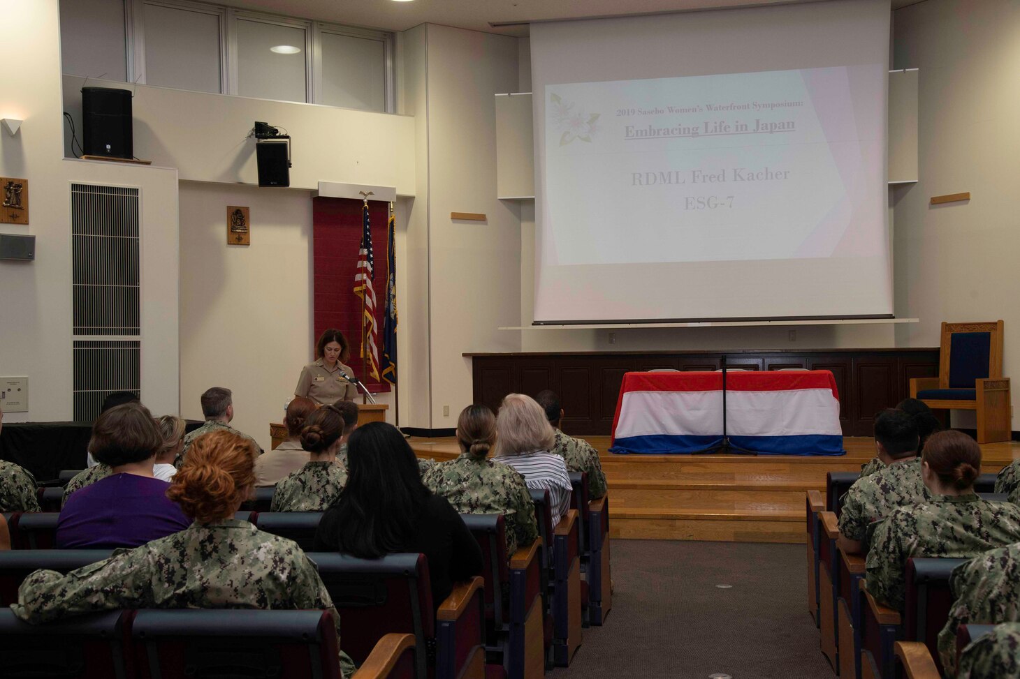 Cmdr. Greta Densham, Naval beach Unit 7 commanding officer, opens the 2019 Waterfront Women’s Symposium at Commander, Fleet Activities Sasebo Sept. 18, 2019.