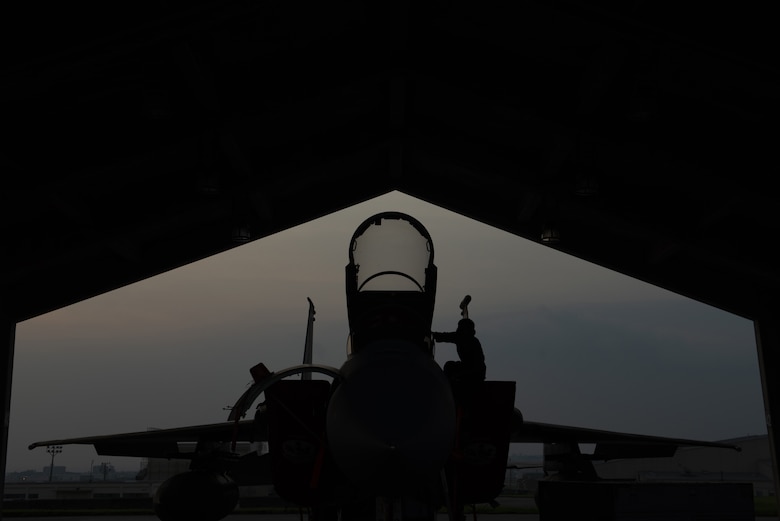 An 18th Aircraft Maintenance Squadron crew chief prepares a 67th Fighter Squadron F-15C Eagle for a mission at Kadena Air Base, Japan, Sept. 16, 2019.