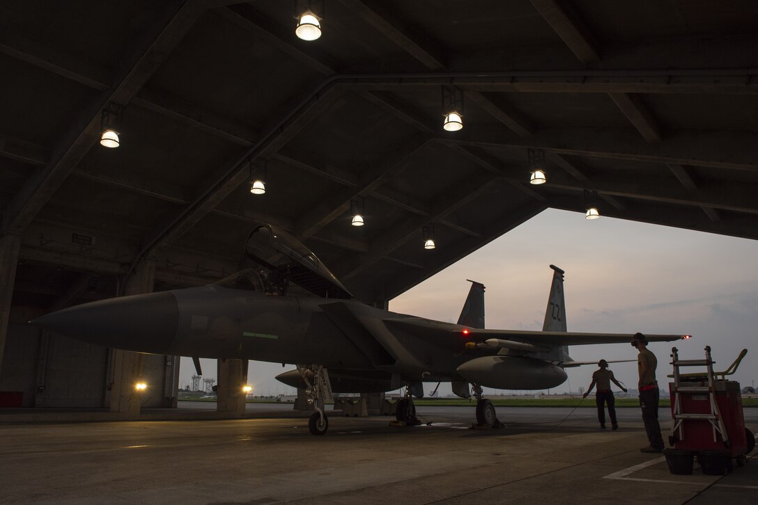 Crew chiefs assigned to the 18th Aircraft Maintenance Squadron prepare a 67th Fighter Squadron F-15C Eagle for a mission at Kadena Air Base, Japan, Sept. 16, 2019.