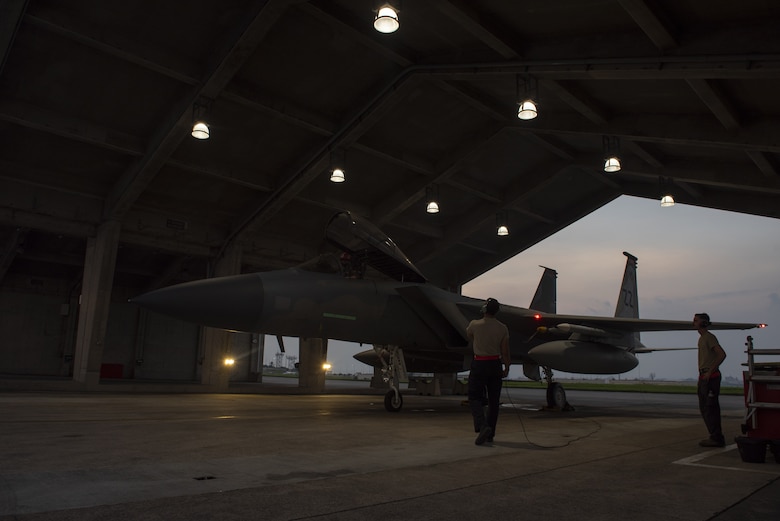 Crew chiefs assigned to the 18th Aircraft Maintenance Squadron prepare a 67th Fighter Squadron F-15C Eagle for a mission at Kadena Air Base, Japan, Sept. 16, 2019.