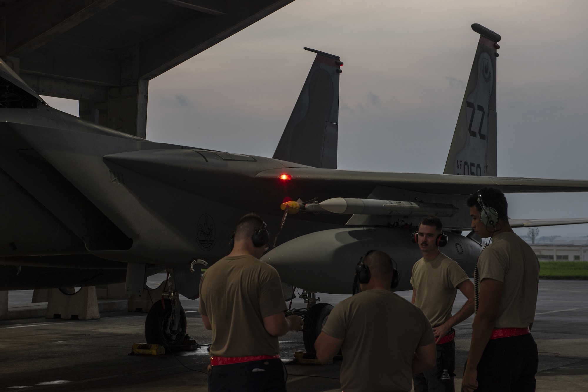 Crew chiefs assigned to the 18th Aircraft Maintenance Squadron discuss the preparation requirements for a 67th Fighter Squadron F-15C Eagle before a mission at Kadena Air Base, Japan, Sept. 16, 2019.