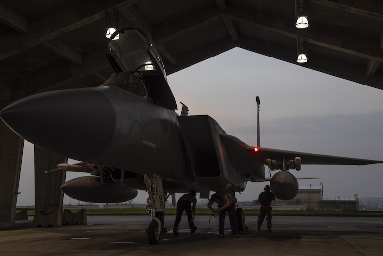 Crew chiefs assigned to the 18th Aircraft Maintenance Squadron prepare a 67th Fighter Squadron F-15C Eagle for a mission at Kadena Air Base, Japan, Sept. 16, 2019.